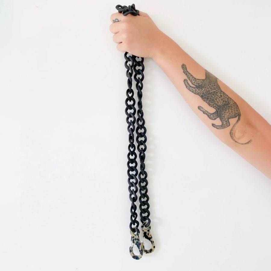 Gabriele Frantzen Matte Black Acrylic Chain Bag Strap held up by a person's arm