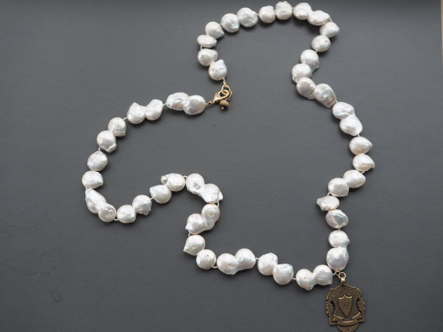 Long Baroque pearl necklace with gold charm