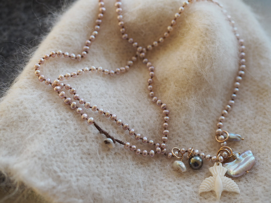 Pink pearls with hawk and pearl charms