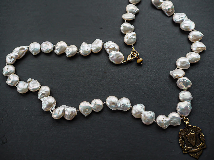 Long Baroque pearl necklace with gold charm