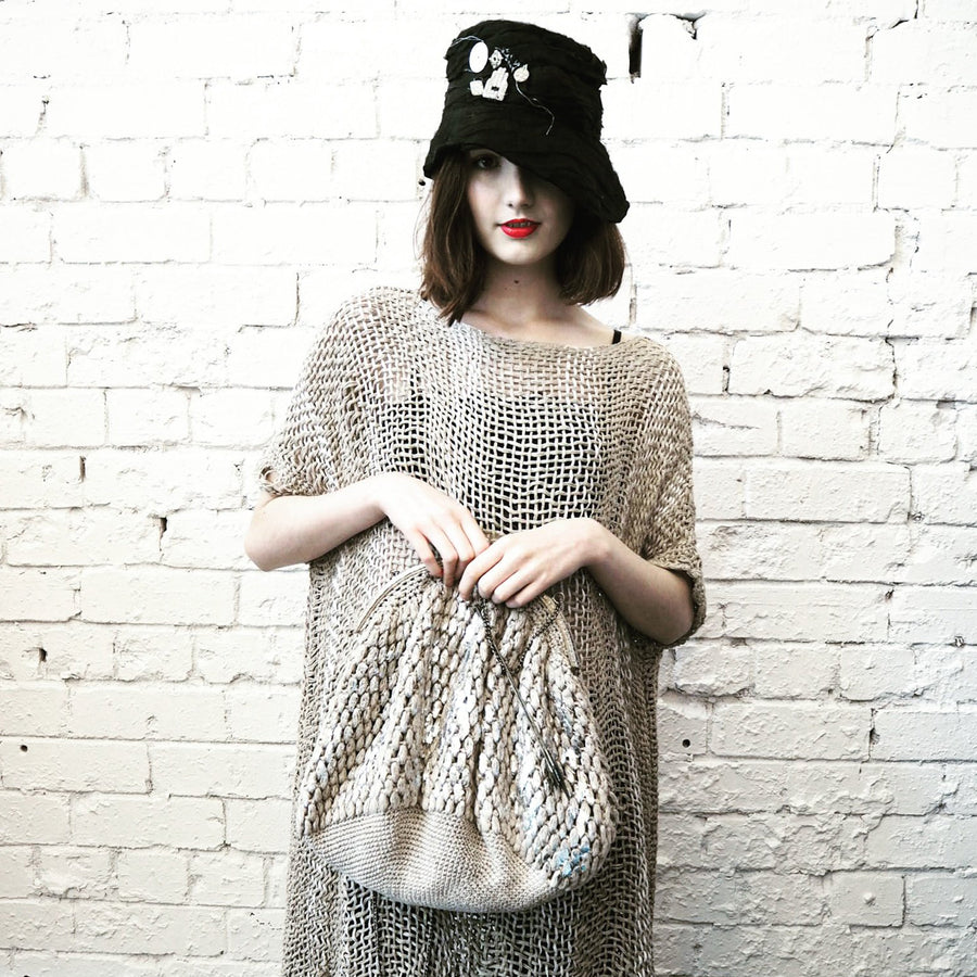 Model holding a natural Hand Crochet Linen Handbag XL from Amano by Lorena Laing