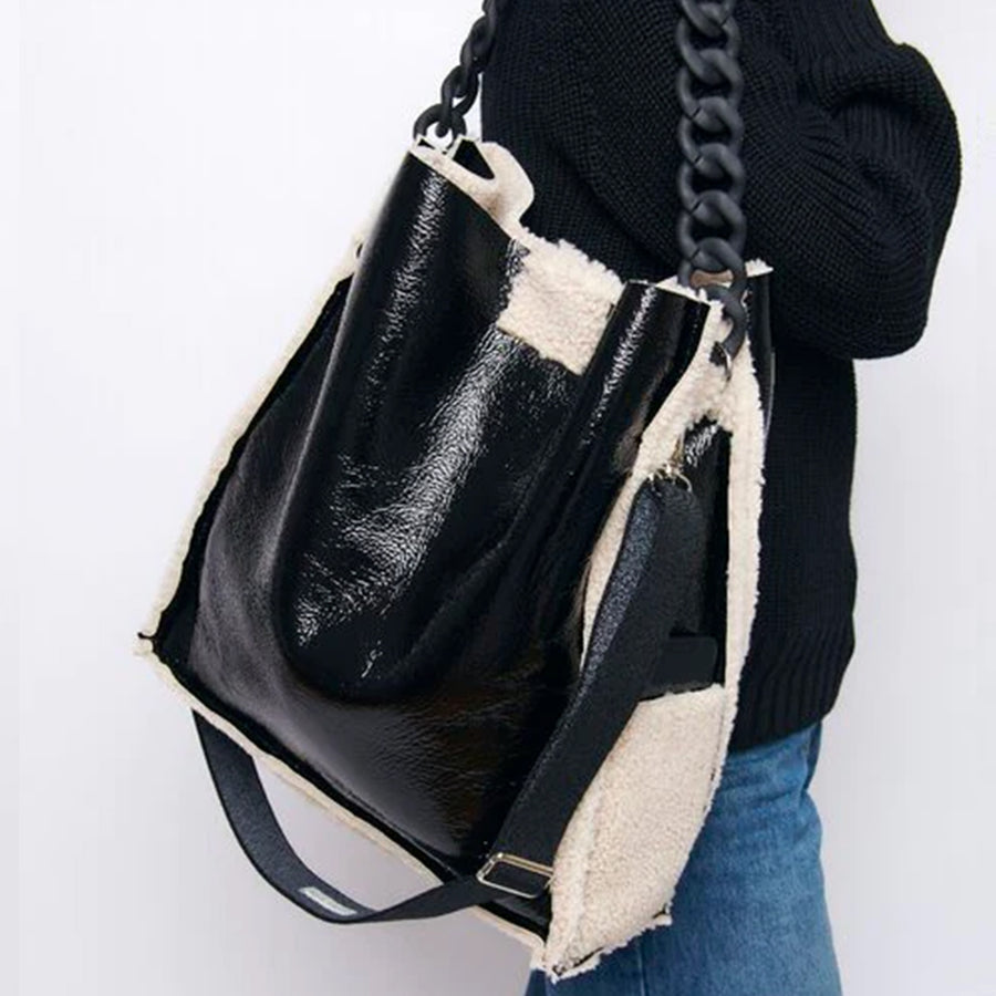 Model holding a Gabriele Frantzen XL Black Cosy Shopper Patent Leather Bag - Lorena Laing
