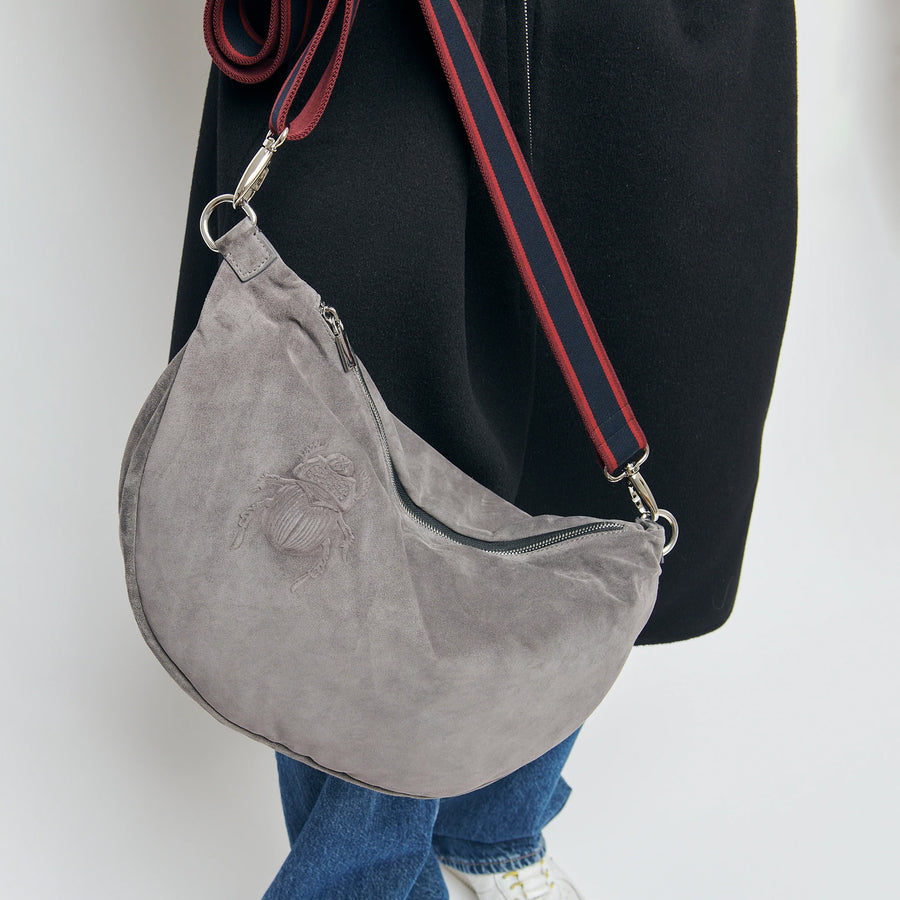 Model holding a Gabriele Frantzen XXL Grey Suede Scarab Belt Bag