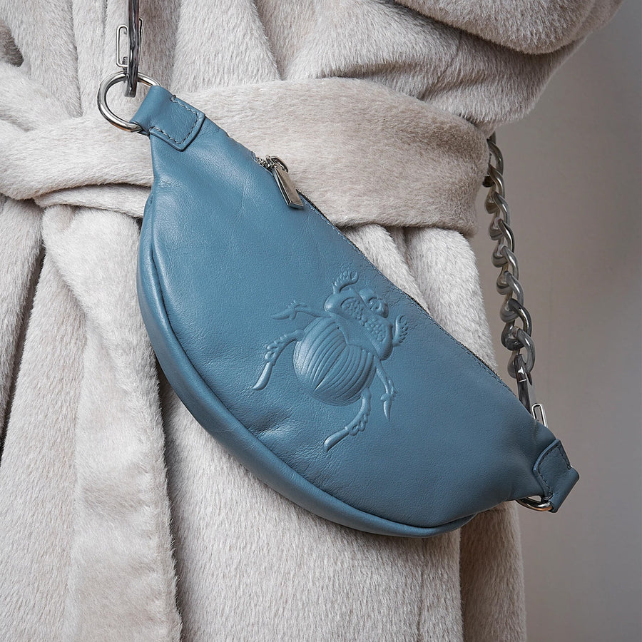 Model wearing a Gabriele Frantzen Pacific Blue Scarab Belt Bag