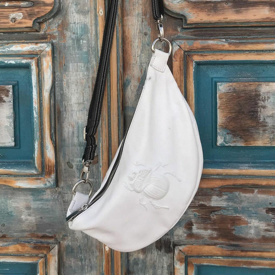 Gabriele Frantzen White Scarab Belt Bag Hanging on door
